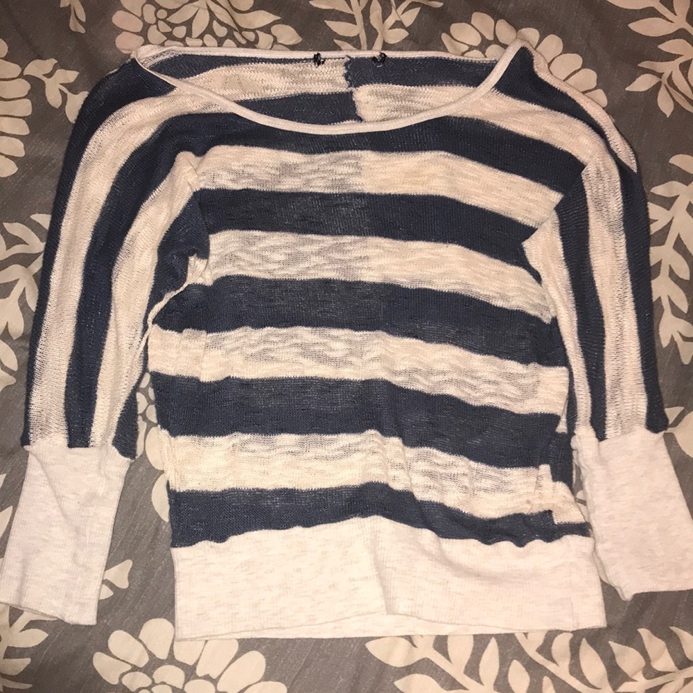 A stripped blue and creme colored shirt